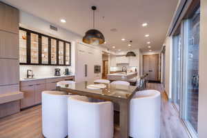 Dining room with recessed lighting and light wood-style flooring
