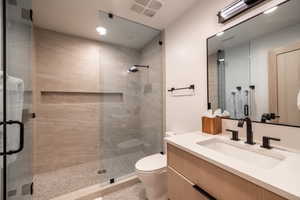 Full bathroom with vanity and a stall shower