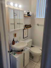 Half bathroom with vanity and light tile patterned floors