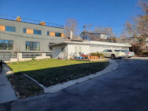 View of front of home featuring a front yard, driveway, and a garage