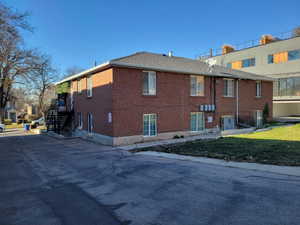 View of home's exterior featuring brick siding and a yard