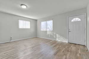 Entryway with light wood-style flooring and baseboards