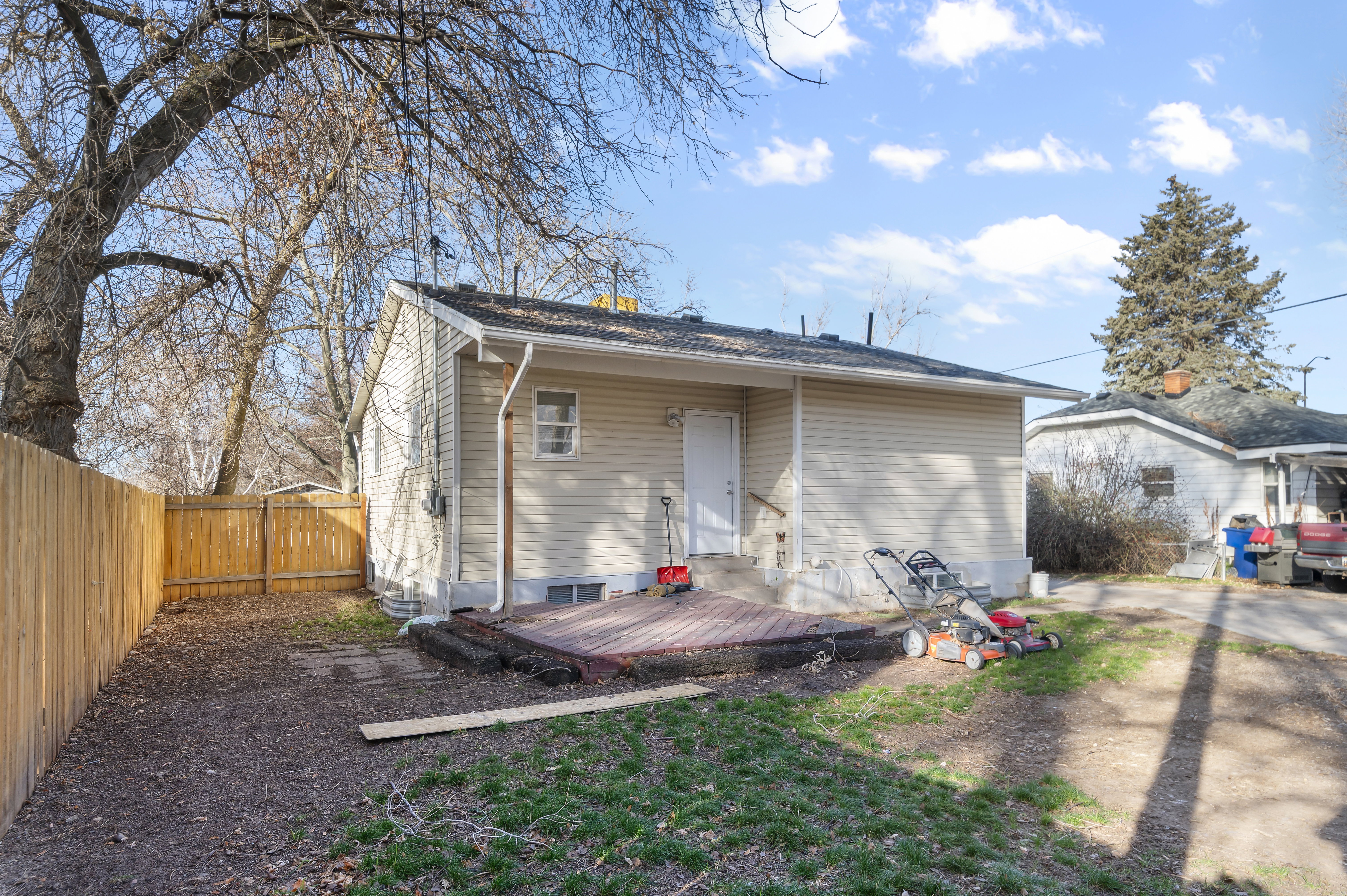 Back of house with a deck and a fenced backyard