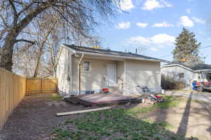 Back of house with a deck and a fenced backyard