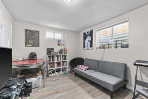 Living area featuring light wood-style flooring and baseboards