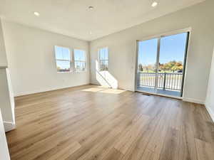 Unfurnished living room featuring light wood-type flooring, recessed lighting, and a textured ceiling