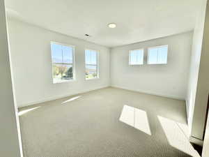 Unfurnished room with carpet flooring and a textured ceiling