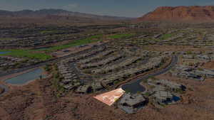 Aerial view of property's location featuring nearby suburban area and a water and mountain view