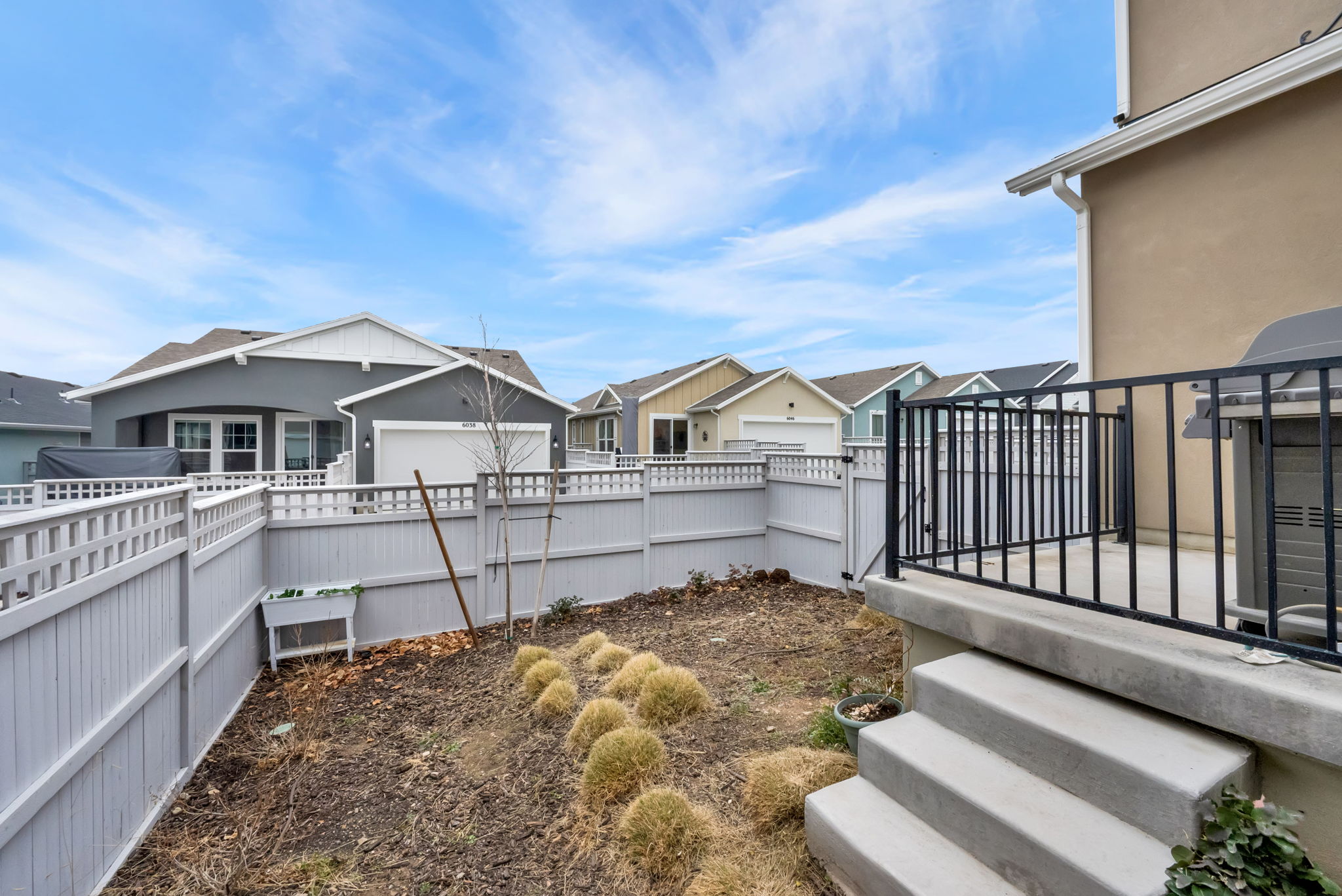Fenced backyard with a residential view