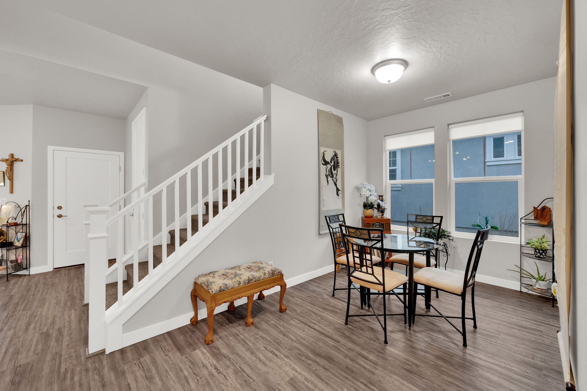 Dining room featuring stairs, wood finished floors, and a textured ceiling