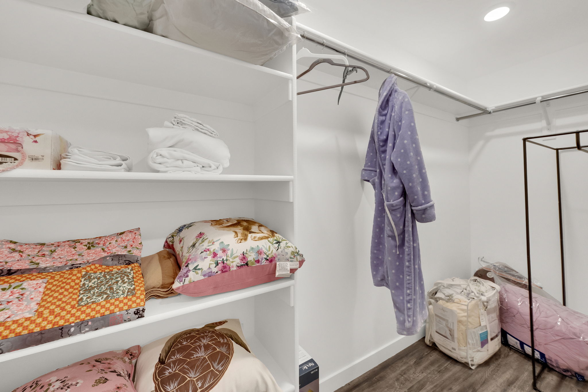 Walk in closet featuring wood finished floors