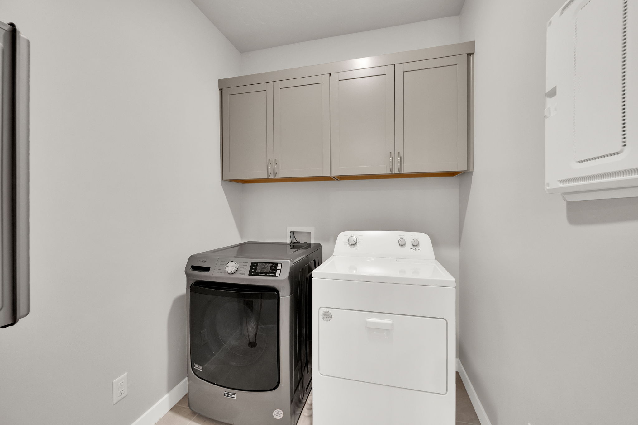 Washroom featuring cabinet space and washer and clothes dryer