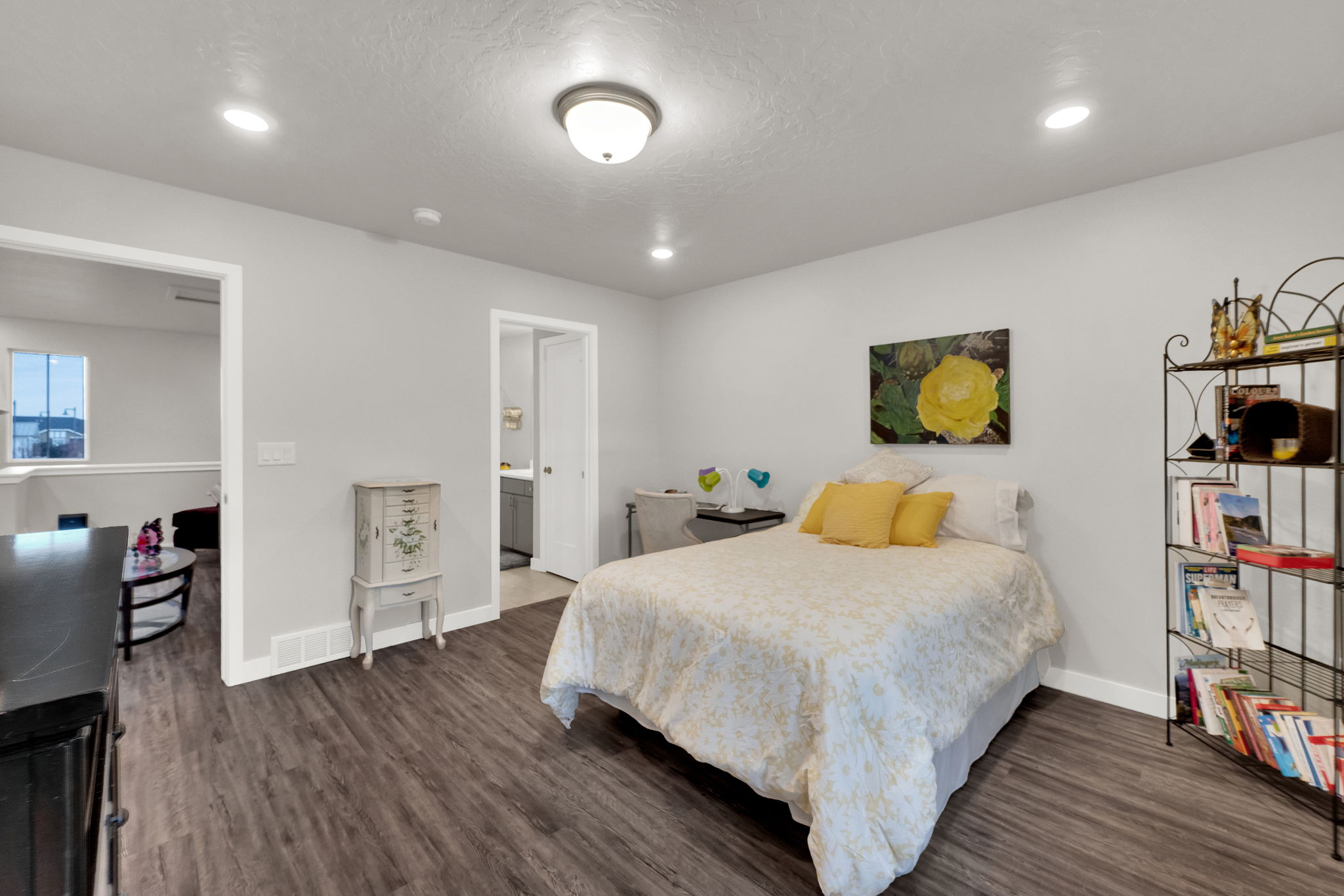Bedroom featuring dark wood-style floors, recessed lighting, connected bathroom, and a textured ceiling