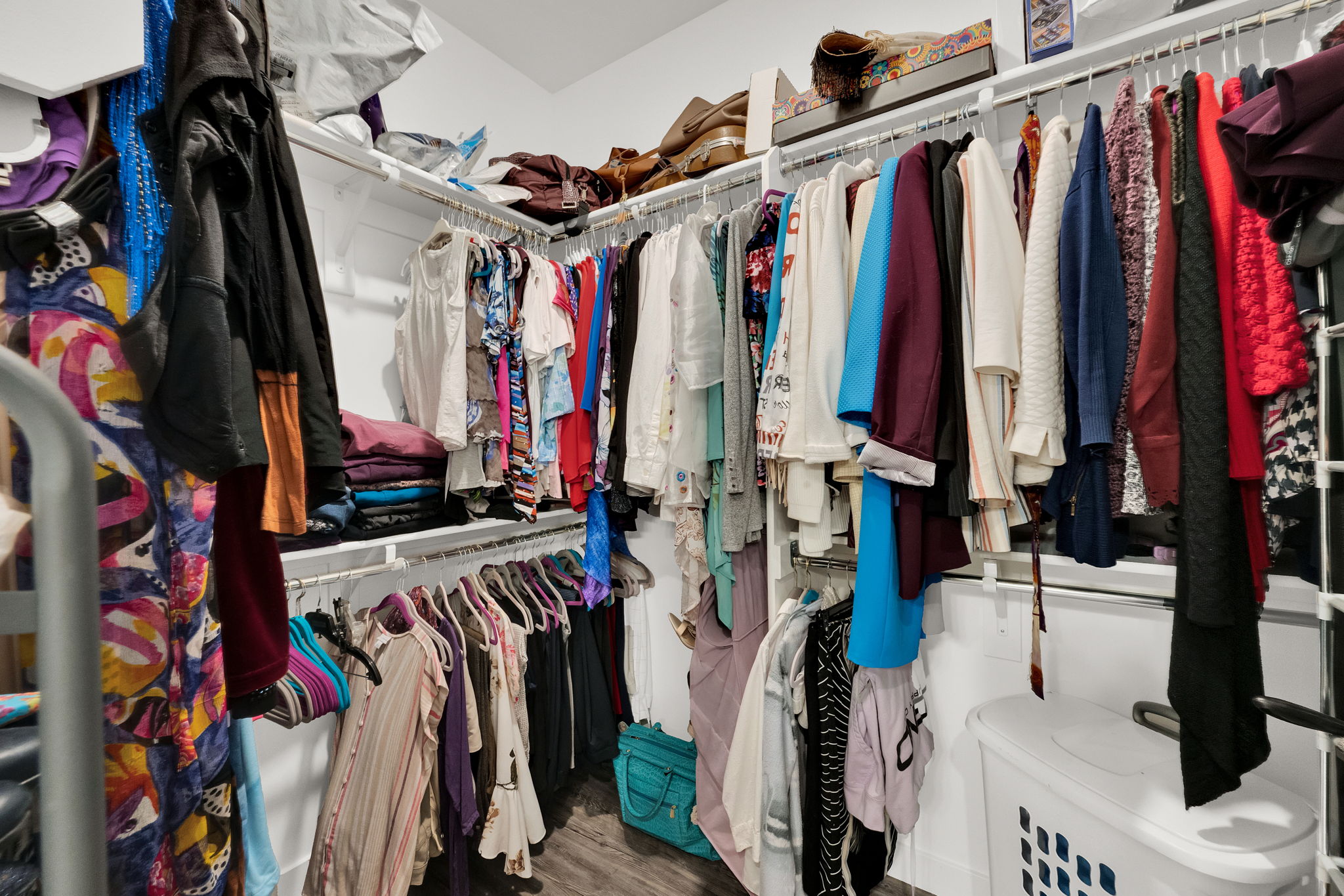 Spacious closet featuring dark wood-style flooring