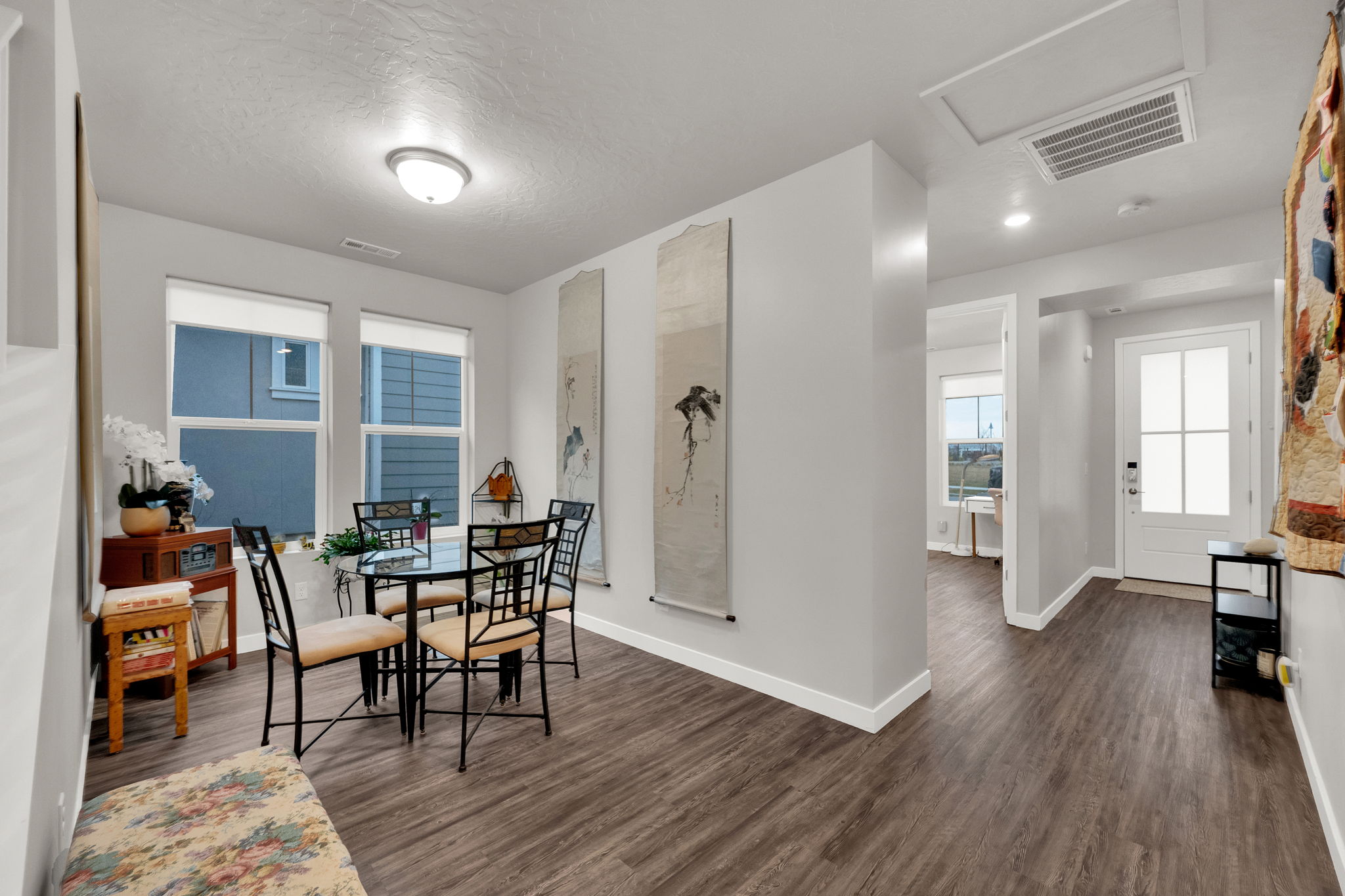 Dining area featuring dark wood-style flooring and a textured ceiling