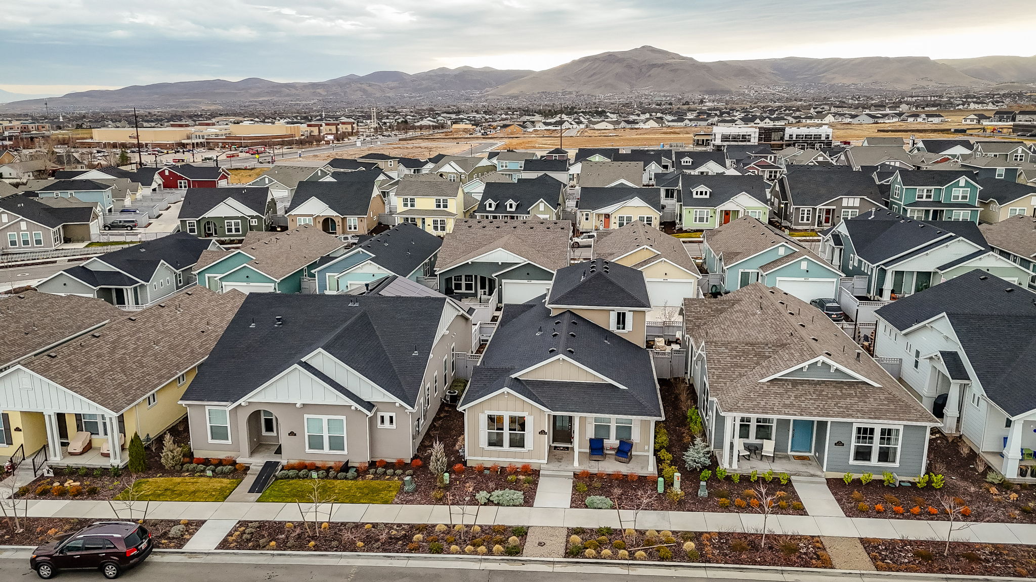 Aerial perspective of suburban area with a mountainous background