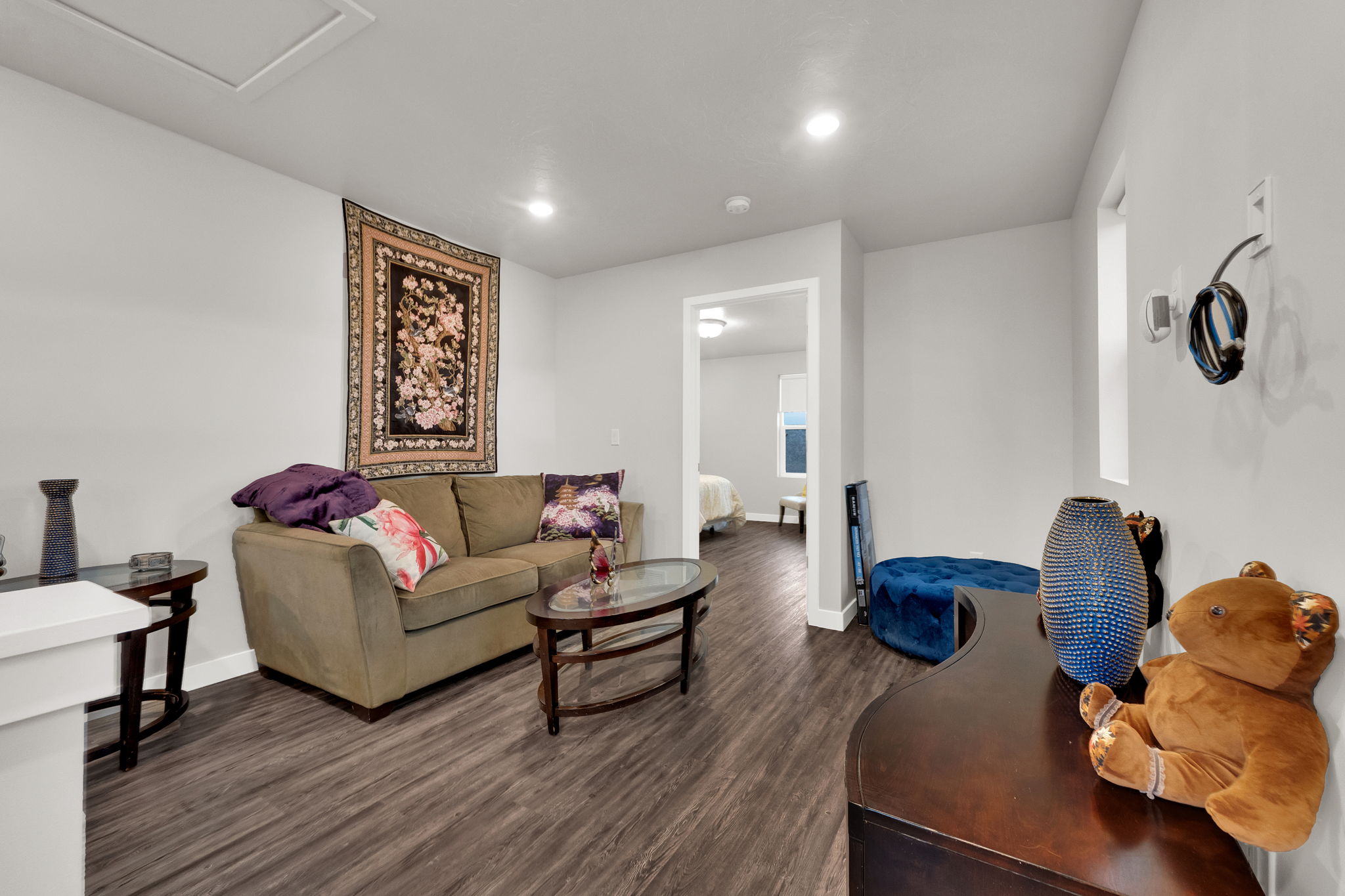 Living room featuring dark wood-type flooring and recessed lighting