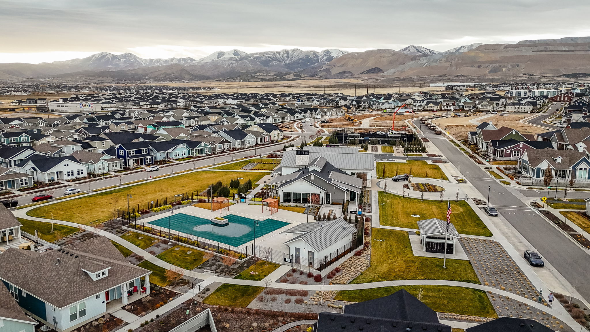 Aerial view of residential area with mountains and a pool