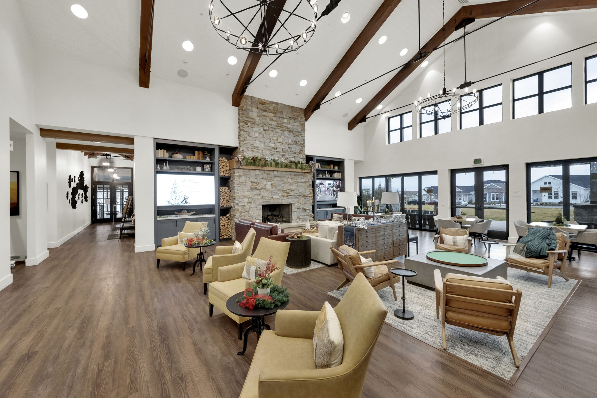 Living room with high vaulted ceiling, recessed lighting, a chandelier, beamed ceiling, and wood finished floors