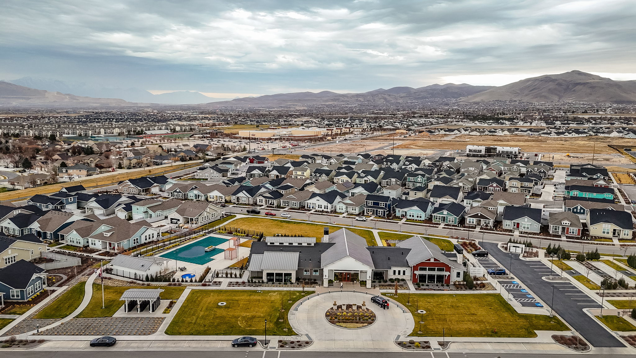 Aerial view of residential area with a mountainous background and a pool area