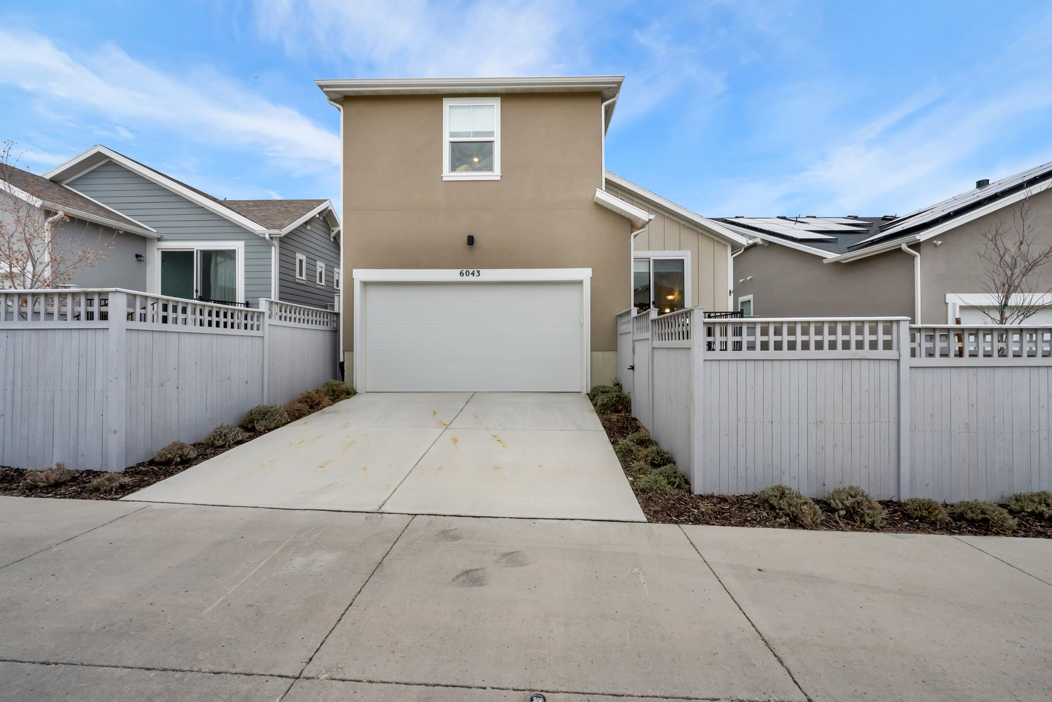 View of home's exterior featuring driveway, a garage, and stucco siding