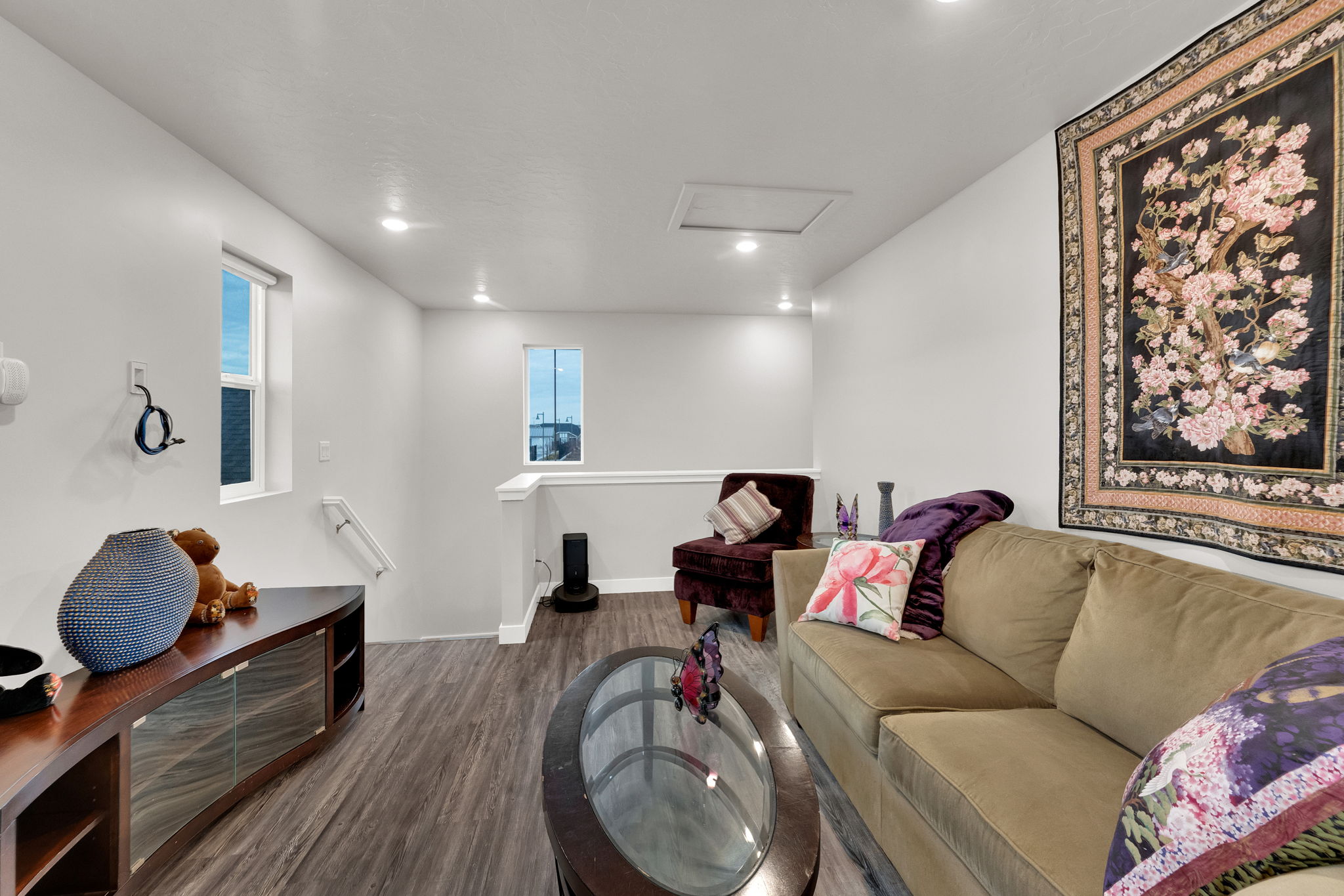 Living room featuring attic access, wood finished floors, and recessed lighting