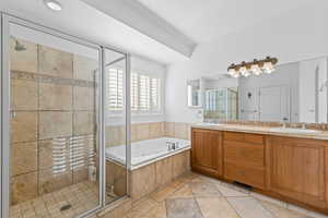 Full bath featuring a shower stall, double vanity, a jetted tub, and stone tile floors
