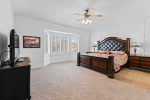 Bedroom featuring light carpet and ceiling fan