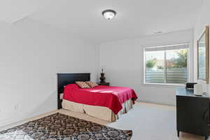 Carpeted bedroom with baseboards