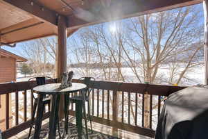 Snow covered deck with a balcony
