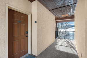View of exterior entry featuring stucco siding