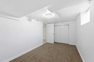 Unfurnished bedroom with carpet flooring and a closet
