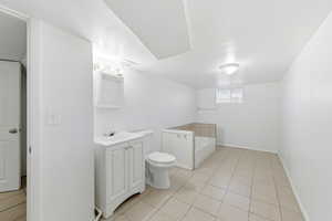Full bathroom with a bath, vanity, and light tile patterned floors