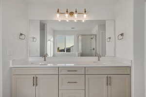 Full bathroom with a stall shower and double vanity
