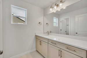 Bathroom with vanity and light marble finish floors
