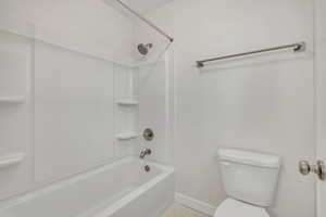 Bathroom with shower / tub combination and toilet