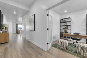 Corridor with recessed lighting, an office area, and light wood-style floors