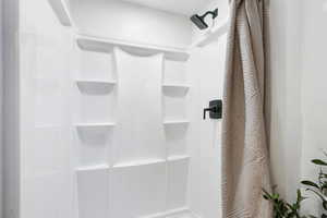 Bathroom featuring a shower with shower curtain