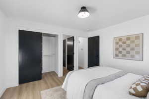 Bedroom featuring light wood-type flooring and a closet