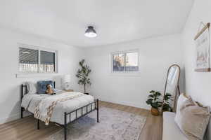Bedroom with light wood finished floors and baseboards