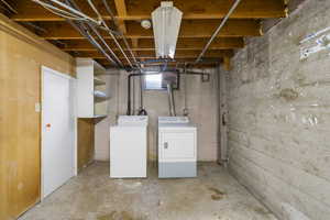 Below grade area featuring washer and dryer