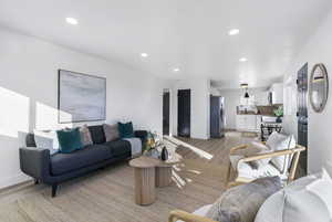 Living room featuring recessed lighting and light wood-style flooring