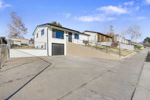 View of front of house featuring an attached garage and driveway