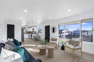 Living room featuring light wood finished floors and recessed lighting