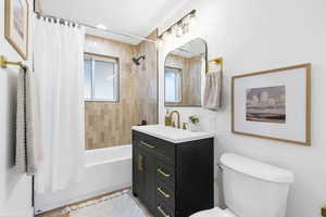 Full bathroom with shower / bath combo and vanity