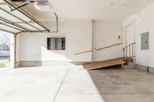 Garage with electric panel and a garage door opener