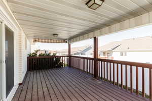 Wooden terrace featuring a residential view