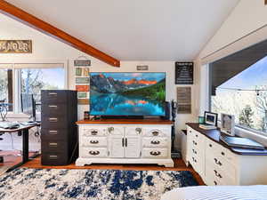 Living area with plenty of natural light and dark wood finished floors