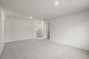 Empty room featuring light colored carpet and recessed lighting