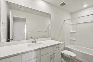 Full bathroom with vanity, tub / shower combination, and recessed lighting